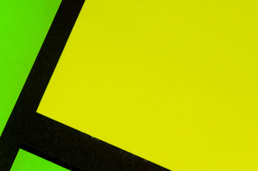 Green and yellow hue colorful office stickers on black paper. Office noteparer as reminder....