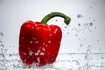 Paprika Splash in Water on white background,sweet pepper drop in the water