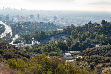 View of Los Angeles from the Hollywood Hills. Down Town LA. Hollywood Bowl. Warm sunny day. Beautiful clouds in blue sky. 101 freeway traffic.