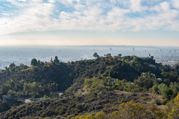 View of Los Angeles from the Hollywood Hills. Down Town LA. Hollywood Bowl. Warm sunny day. Beautiful clouds in blue sky. 101 freeway traffic.