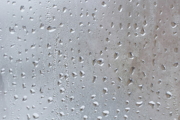 Rain drops on the window glass closeup