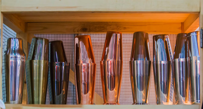 Gold and copper glasses and cookware for cocktails are at the bar