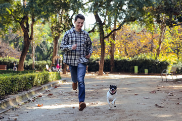 Fototapeta premium Brunette boy running with his dog