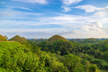 Chocolate Hills, blue sky with clouds. Unique place in Bohol, Philippines.