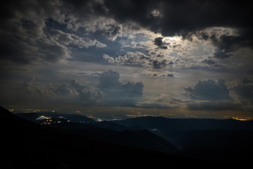 Dramatic night with clouds and moon in mountains