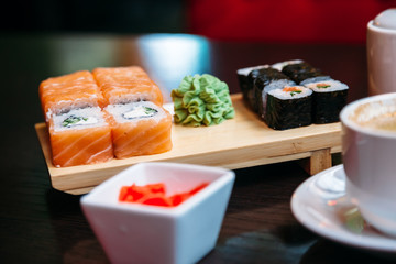 cup of coffee and sushi on table