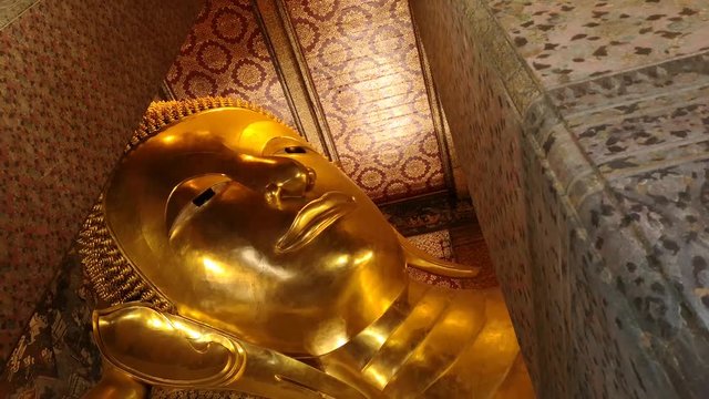 Reclining buddha at Wat Pho or Wat Phra Chetuphon Vimolmangklararm Rajwaramahaviharn which is one of Bangkok's oldest temples in Bangkok.