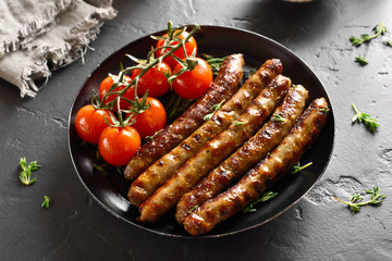 Roasted sausages and cherry tomatoes