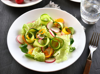 Vegetable salad from zucchini, radish, greens
