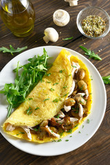 Omelet with mushrooms, chicken meat, greens
