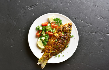 Grilled fish with salad