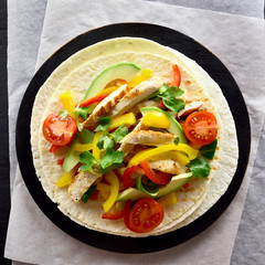 Taco with chicken meat and vegetables