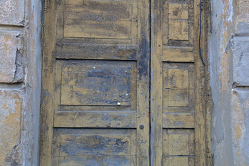 Dilapidated wooden entrance door in an abandoned house