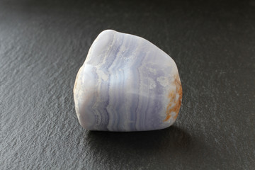 A blue agate stone on a black stone board