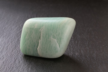 Aventurine stone on a black stone board