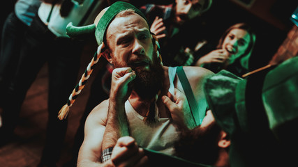 Obraz premium Two Men Fight In Pub. Saint Patrick's Day Concept.