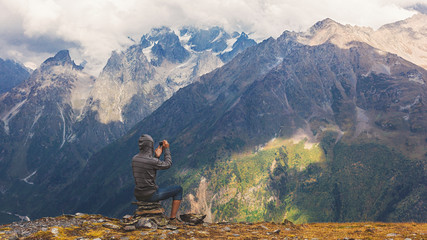 tourist taking pictures of the mountains