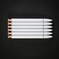 white pens on black background