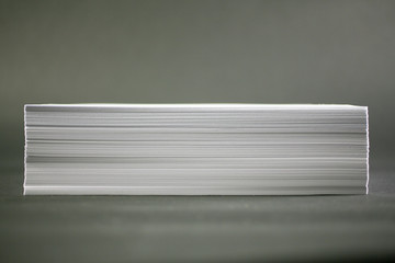 stack of paper on grey background