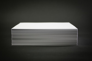 stack of paper on black background