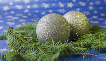 Christmas balls and fir branches on a light star background