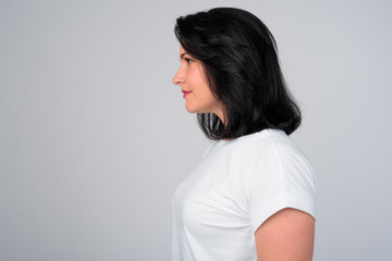 Profile view of beautiful woman with short hair against white background