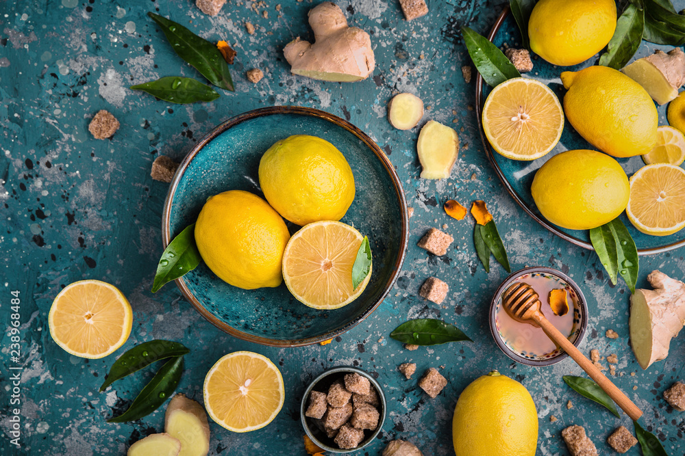 Wall mural Ingredients for cold tea: lemon, ginger and honey. Food and drink, healthcare concept. Colorful still life