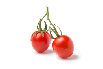 fresh cherry tomatoes on branch isolated on white.