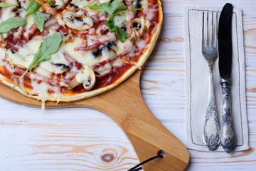 Tasty and flavorful pizza on the table. Appetizing homemade pizza.