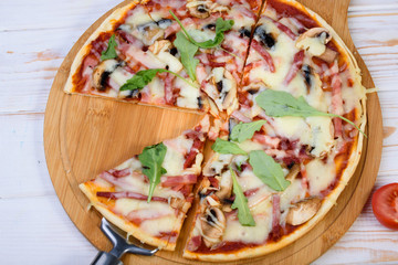 Tasty and flavorful pizza on the table. Appetizing homemade pizza.
