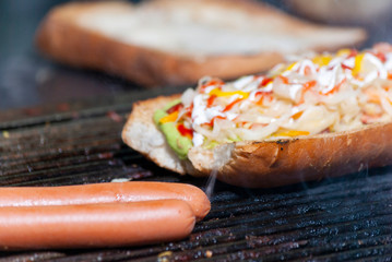  fast street food in the city of guatemala, bread with cabbage sausage, meat, sauces, roasted charcoal called Shuco.