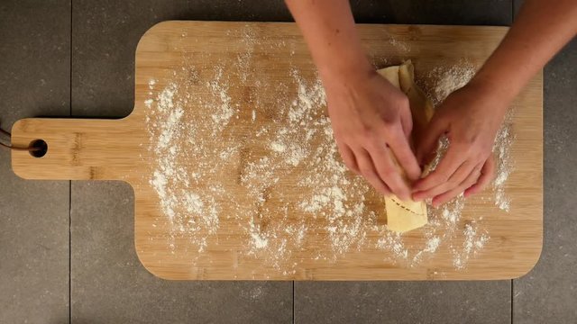 Close up, placing dough on cutting board
