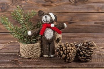 Christmas toy - a small bear made of wool in Santa clothes