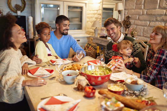 Multi Ethnic Friends Have Fun At A Family Christmas Dinner.