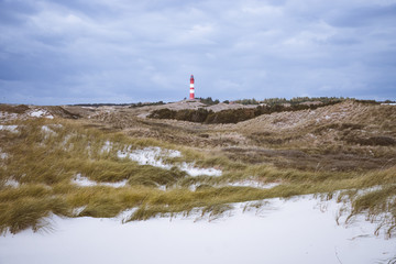 Lighthouse in a dunes landscape in in Amrum Germany.