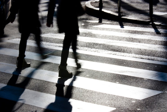 Fototapeta Blurry zebra crossing with pedestrians