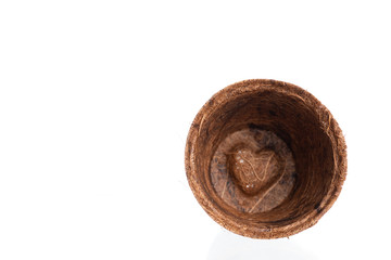 Fototapeta na wymiar Empty flowerpot made from coconut fiber isolated a on white