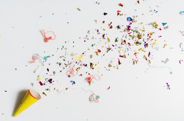 Exploding party popper on white background - 238973039