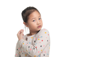 Cute kid southeast asian girl age 7 years in acting with cotton bud isolated on white