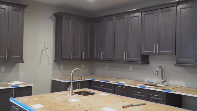 Custom kitchen cabinets in various stages of installation base for Installation of kitchen cabinets