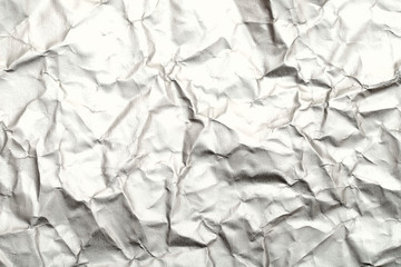 Blurred abstract background of crumpled white paper surface. Cropped shot, horizontal, blurred, top view.