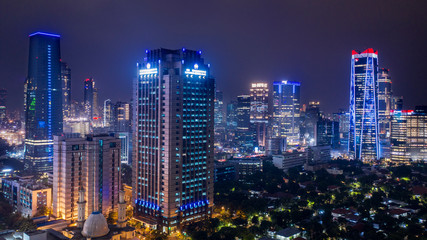 Fototapeta na wymiar Skyscrapers with glowing light in Jakarta downtown