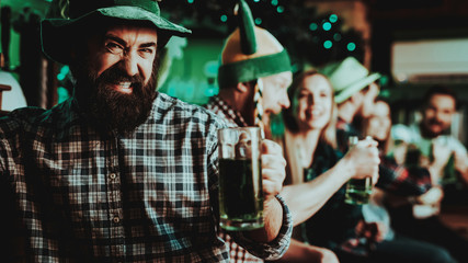 Guy In The Leprechaun Cap Is Drinking A Beer.
