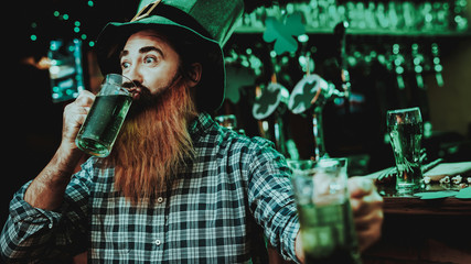 Guy In The Leprechaun Cap Is Drinking A Beer.