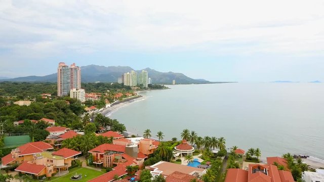 Aerial shot of beautiful condo, pool, jungle, mountain, volcano, villas.