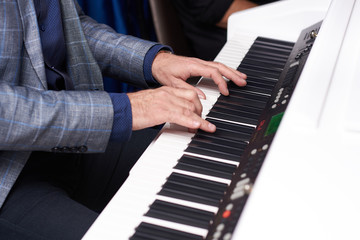 Fototapeta na wymiar man playing the piano, close-up, hands