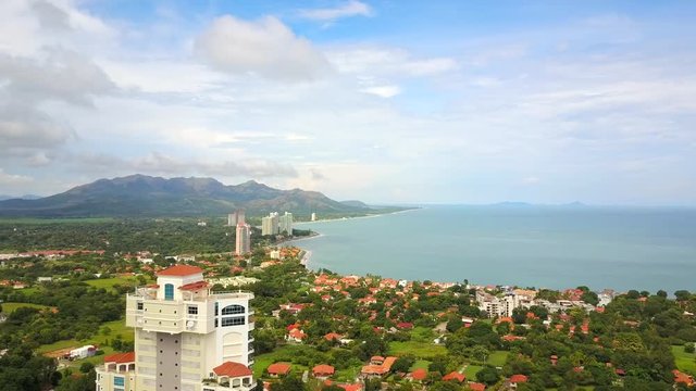 Aerial shot of beautiful condo, pool, jungle, mountain, volcano, villas.