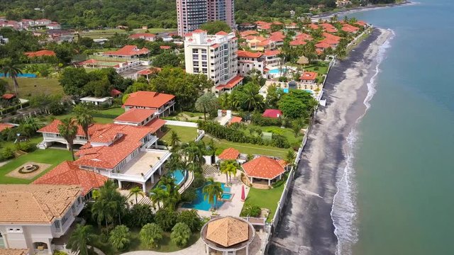 Aerial shot of beautiful condo, pool, jungle, mountain, volcano, villas.