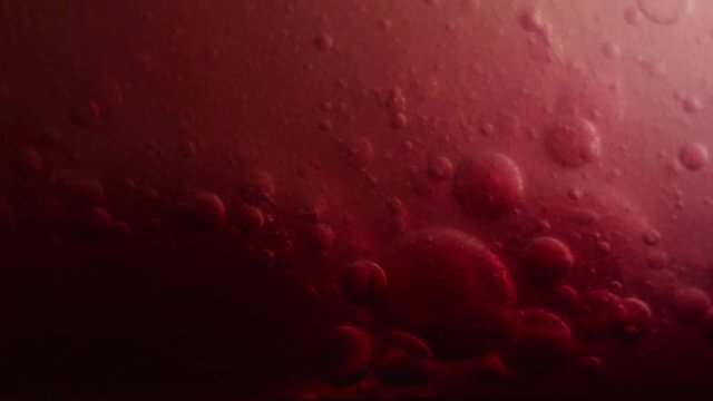 Bubbles surging and pumping; red color reminiscent of blood and plasma fluids.