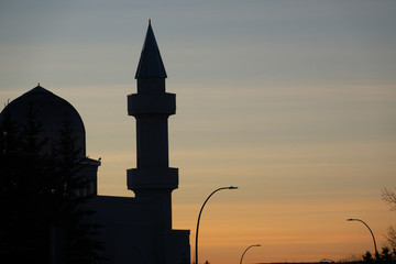 Silhouette of mosque minaret in city downtown